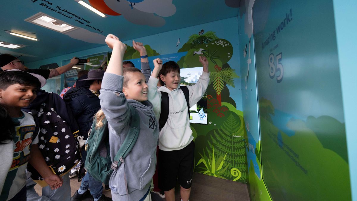 Photo of kids loving the Raindrop Rescue game in Watercare Wonder Wai Discovery Centre