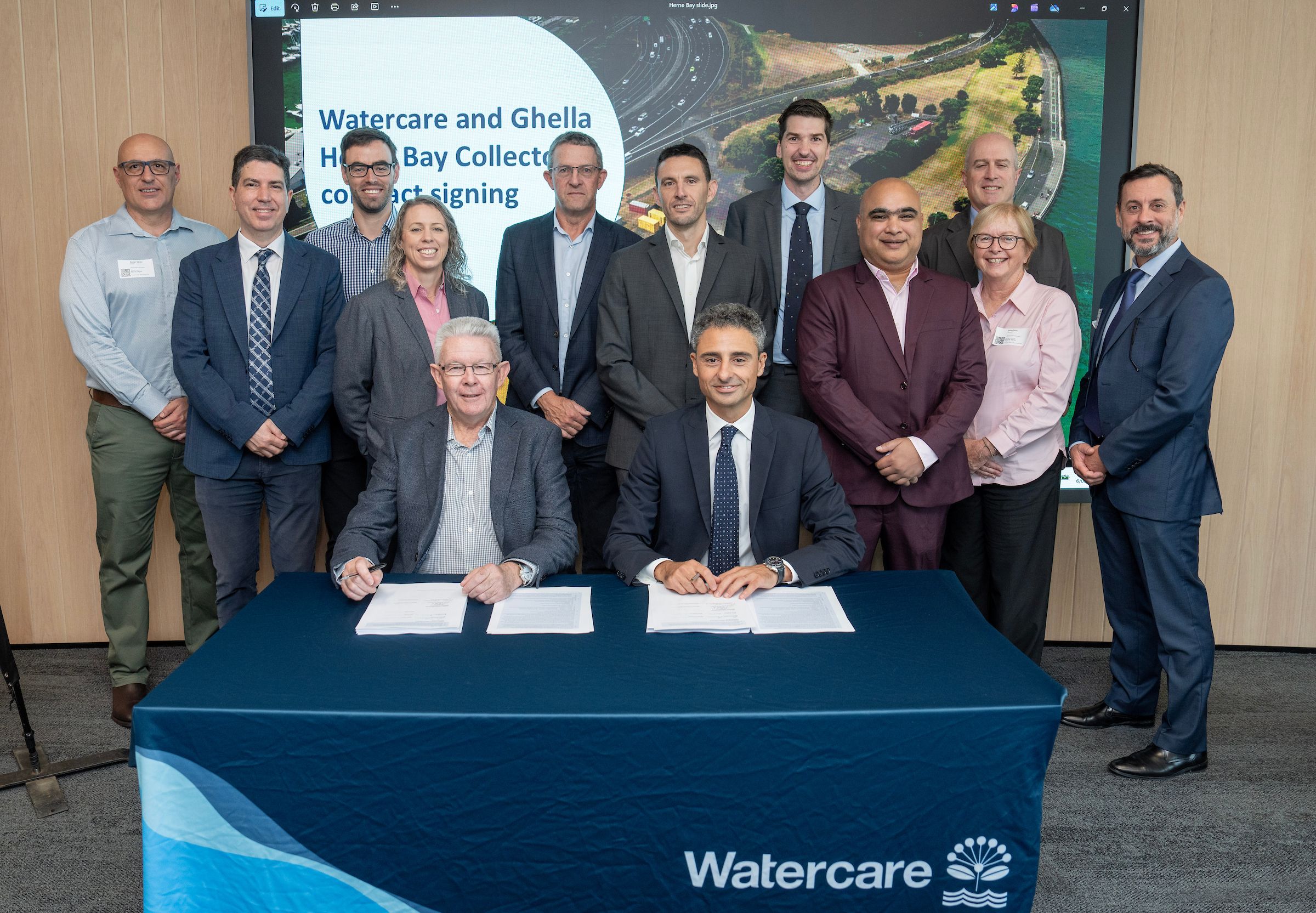Watercare's Mark Crowle, seated on the left, and Ghella's Rosario Barresi, seated on the right, pictured with the team at the contract signing.jpg