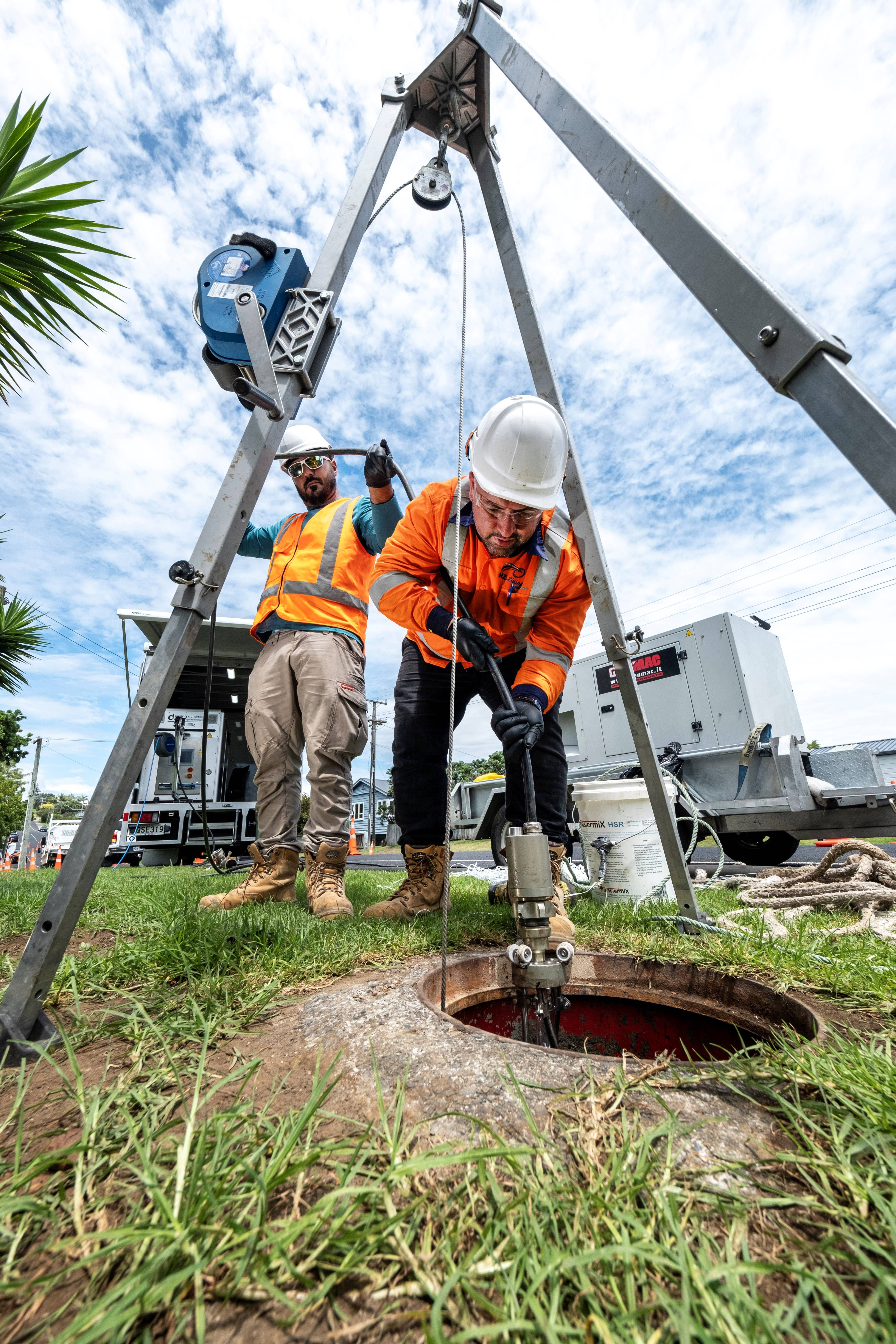 a_small_cctv_rover_is_lowered_into_a_manhole_jpg